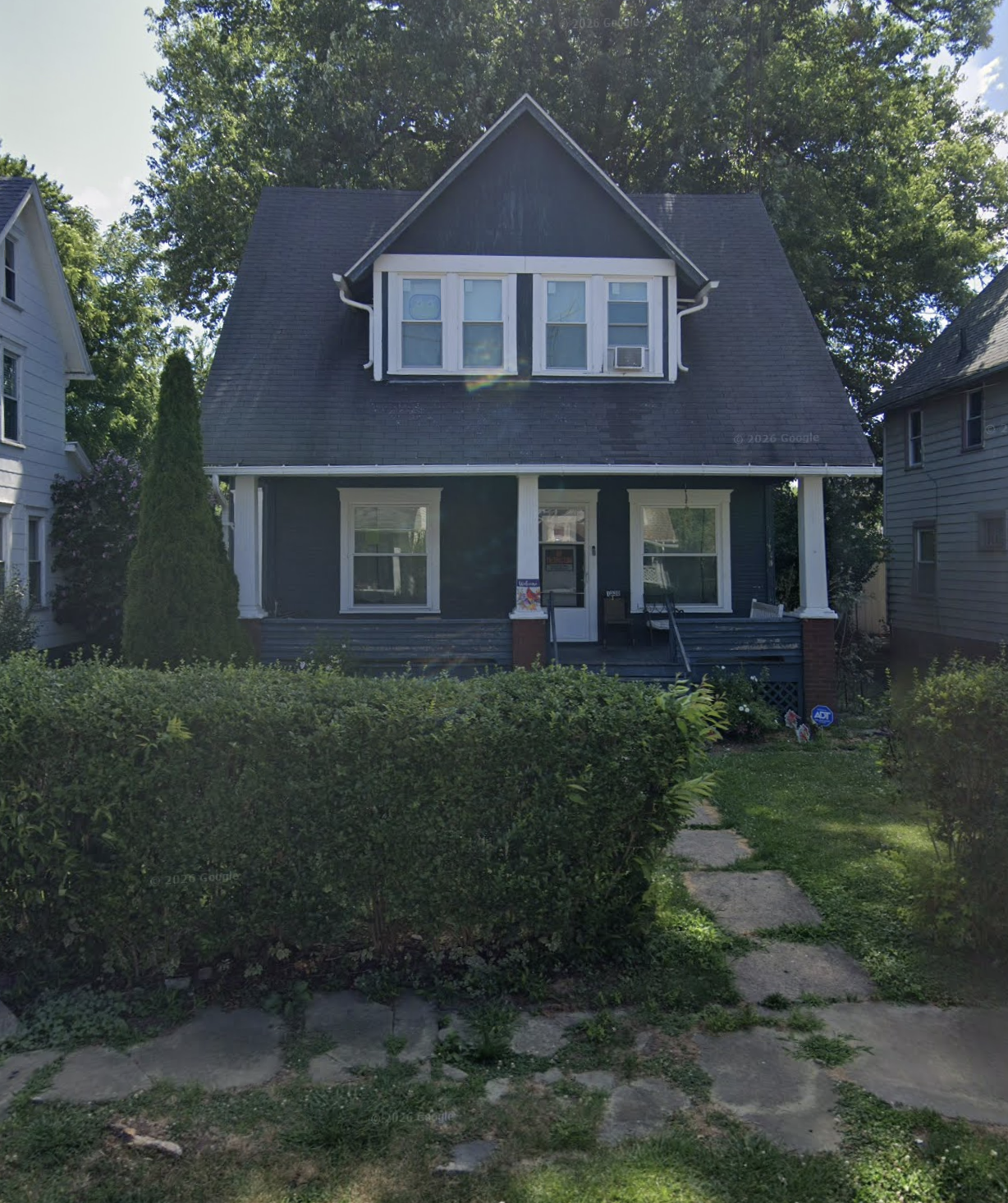 Dark two-story home with porch