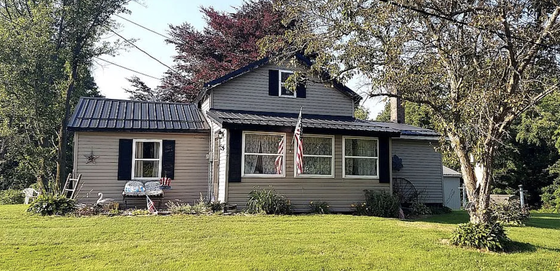 Farmhouse with metal roof and American flag