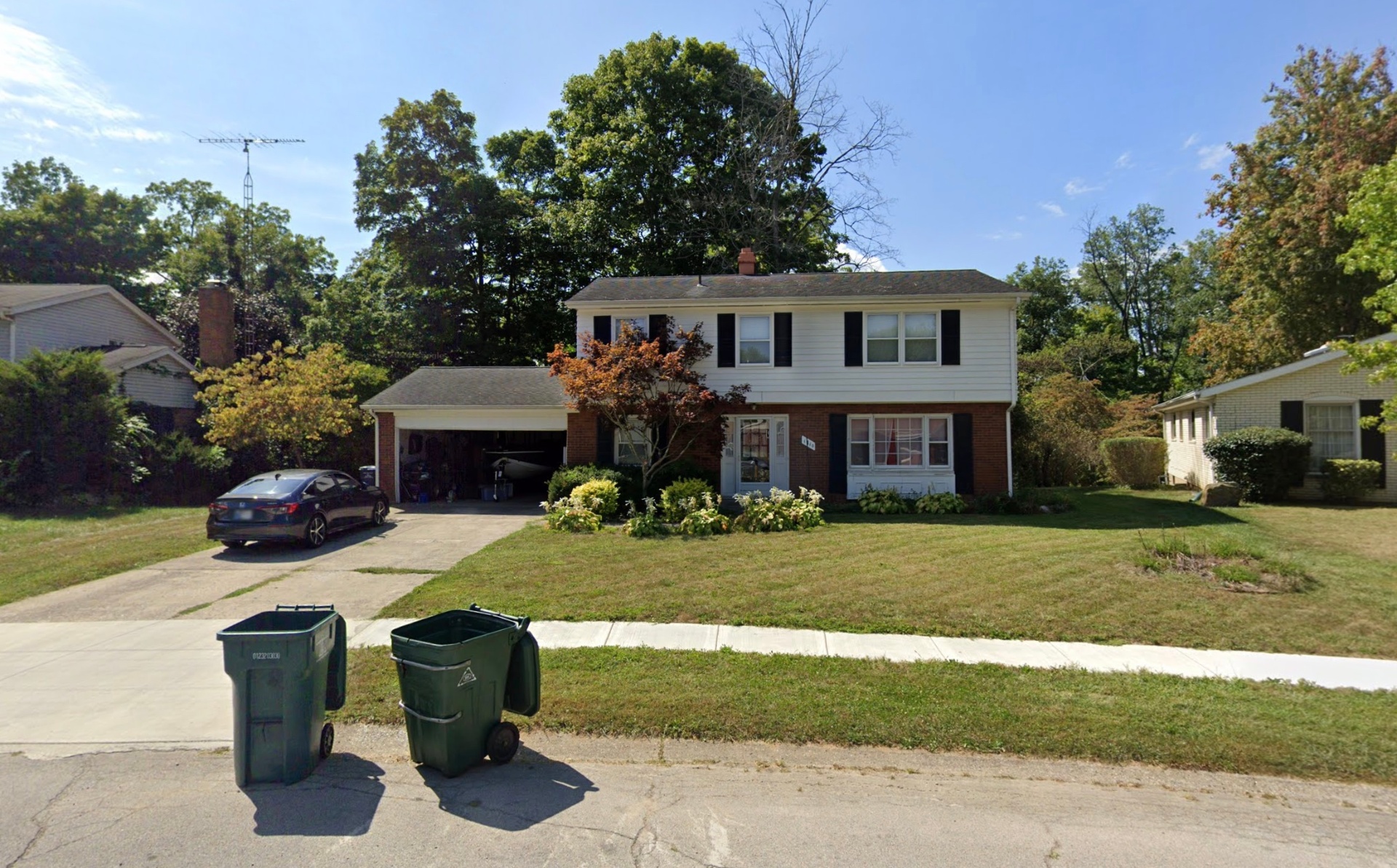 Two-story colonial with brick and garage
