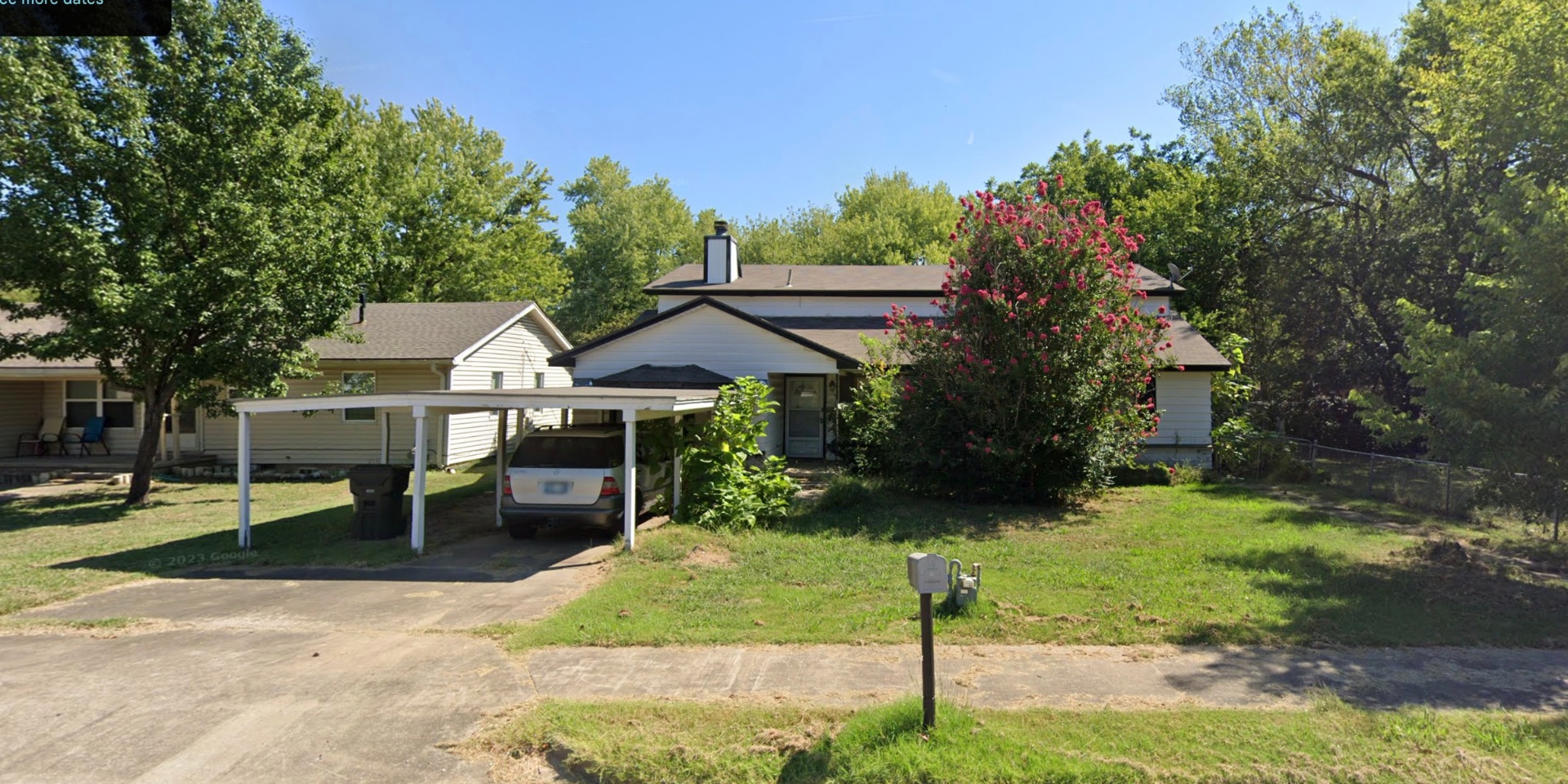 Ranch home with carport and crepe myrtle