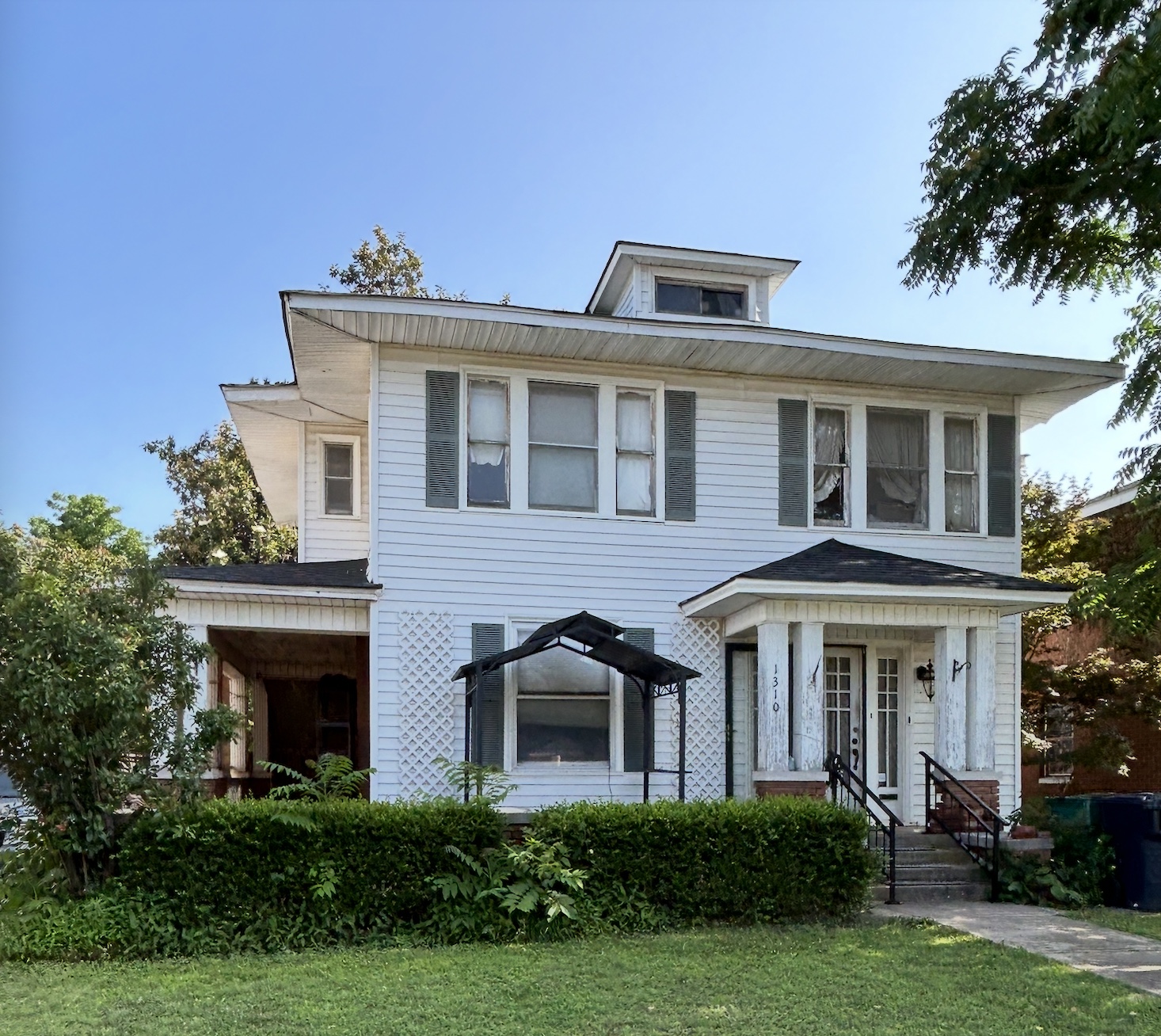 White Foursquare home with green shutters