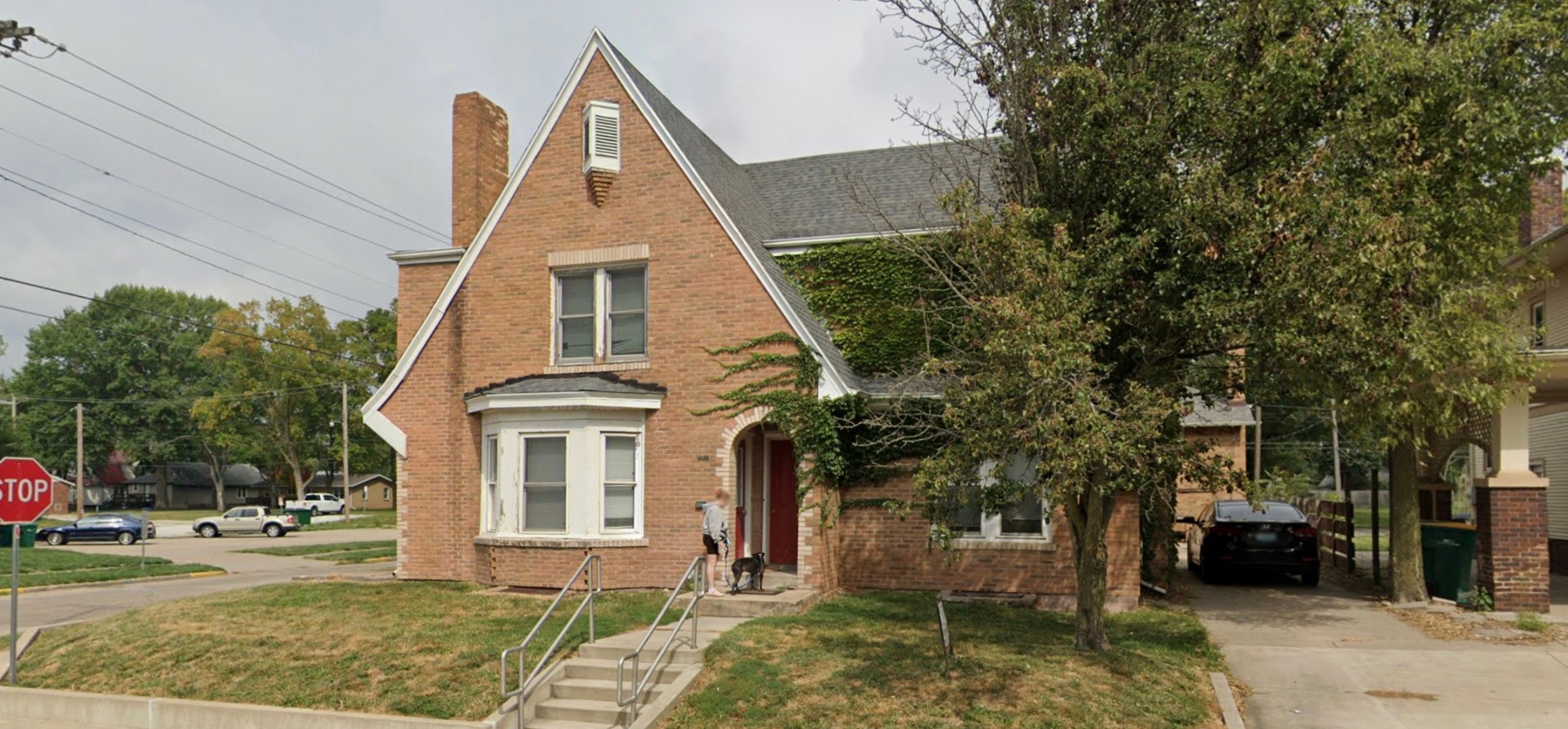 Brick Tudor home with bay window and chimney