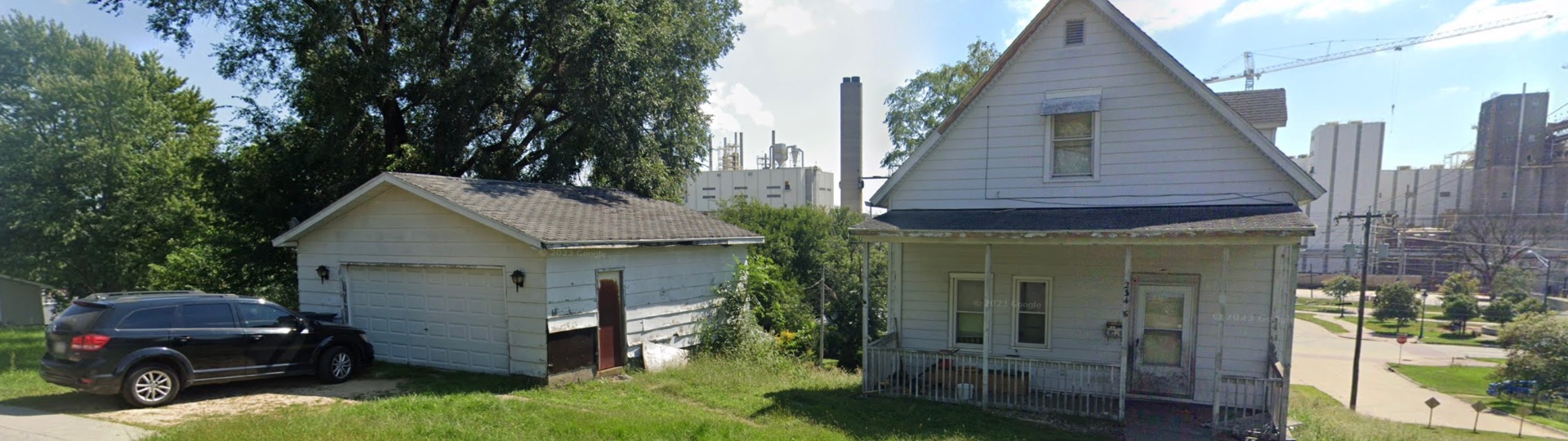 White cottage home with detached garage