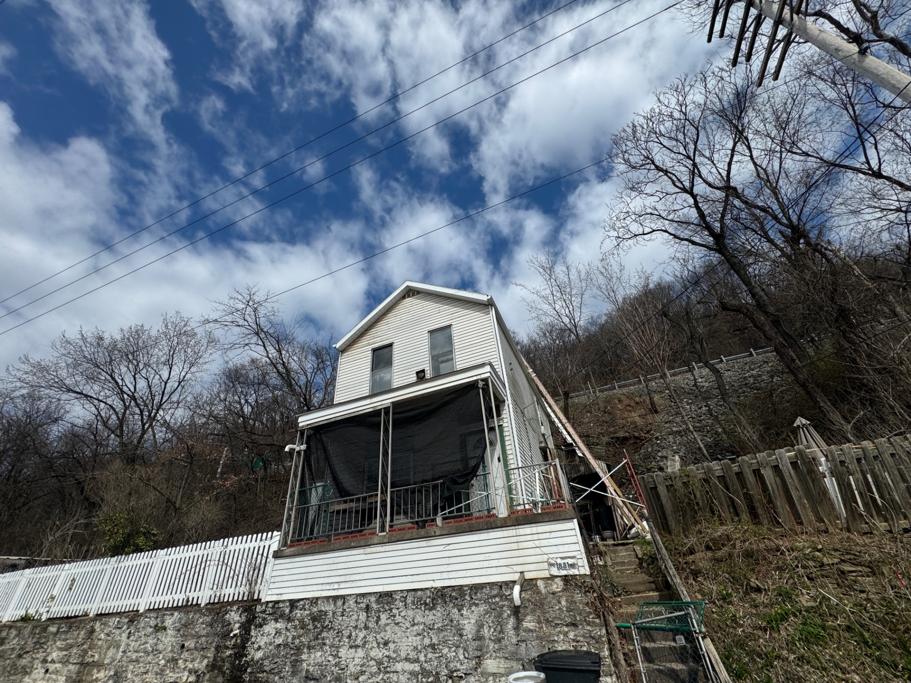 White hillside home with covered porch