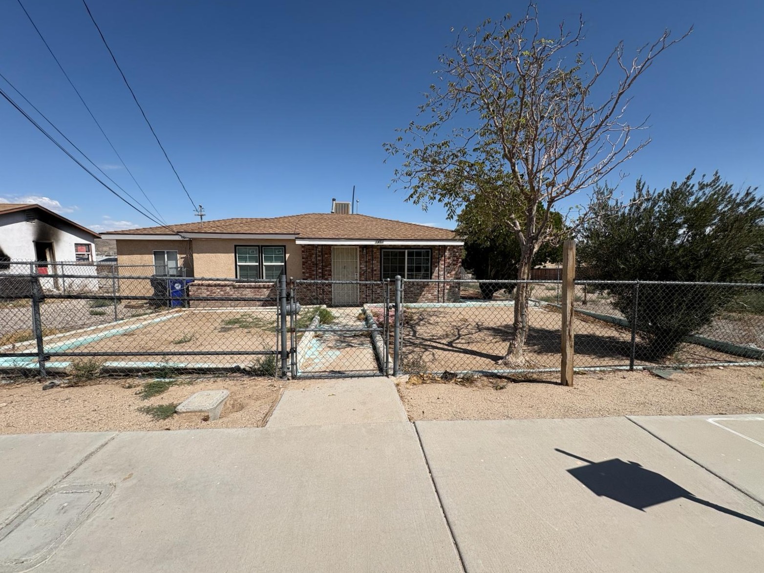 Desert ranch home with chain-link fence